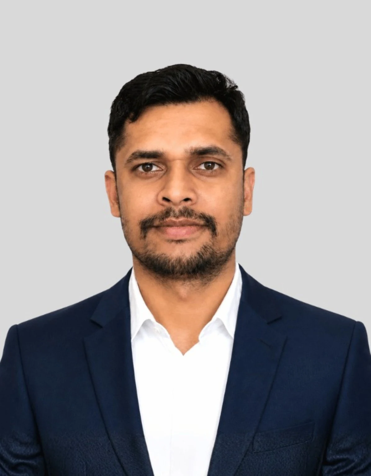 Raju Kumar Mishra in a navy suit in a premium lobby